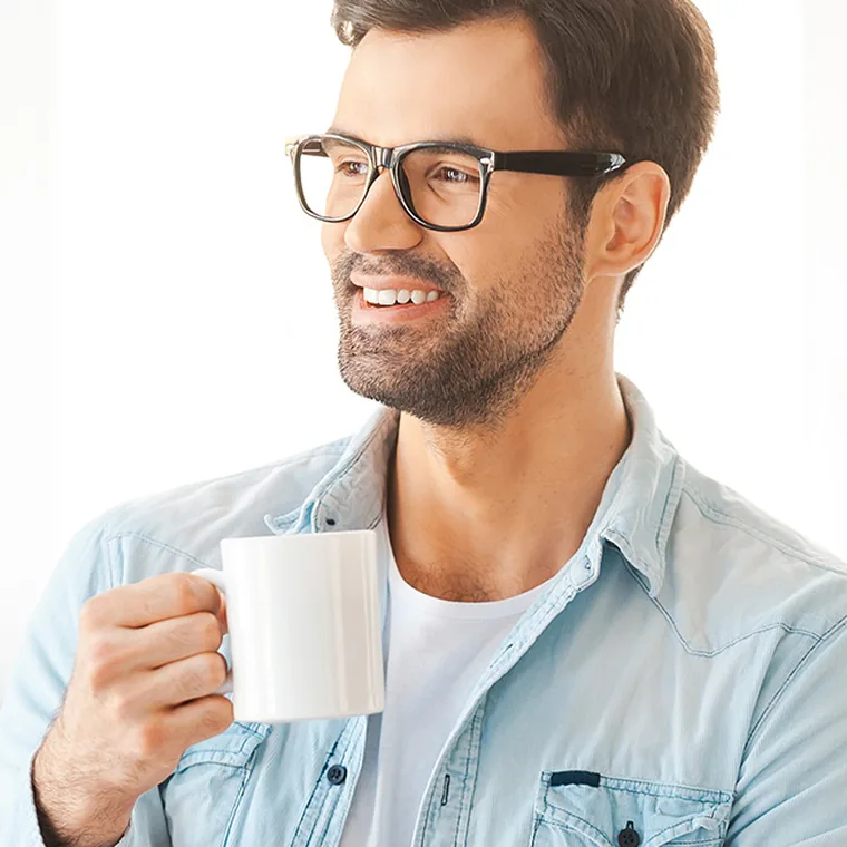 A relaxed patient holding a mug and smiling